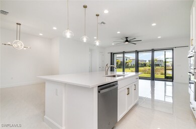 Kitchen featuring dishwasher, a sink, open floor p