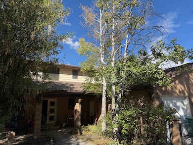 Rear view of property with brick siding