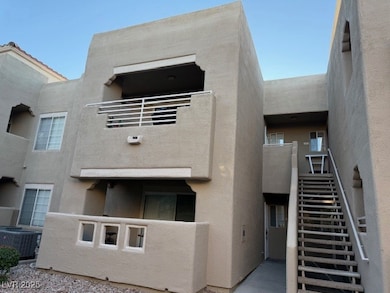 View of property with stairway and central AC unit