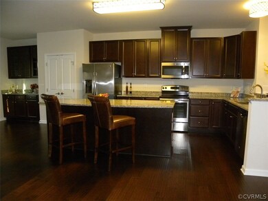 Kitchen has large island with bar area, granite co