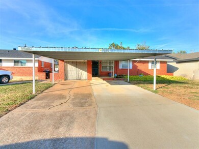 Ranch-style home featuring a carport and a front y