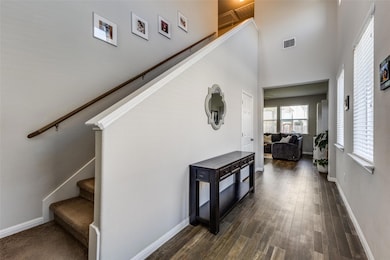 Stairway featuring a towering ceiling, wood finis