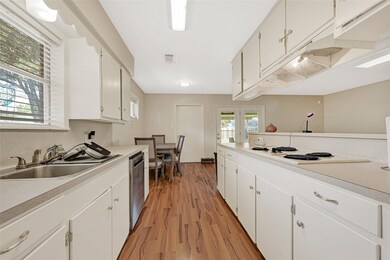 Sun-filled kitchen with a wide window over the sink, offering beautiful backyard views.