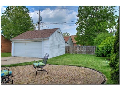 Brick Patio overlooks the Partially Fenced Backyar
