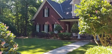 View of front of home featuring brick siding private courtyard and complete privacy. Concrete walkway with pavers and Emerald Zoysia sod.