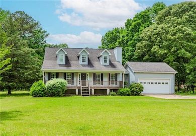 New england style home featuring covered porch, a 
