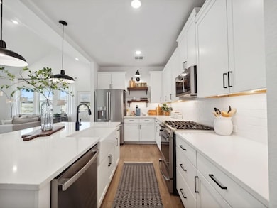Kitchen with pendant lighting and floating shelves