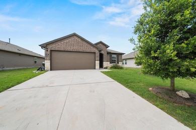Ranch-style house with brick siding, an attached 
