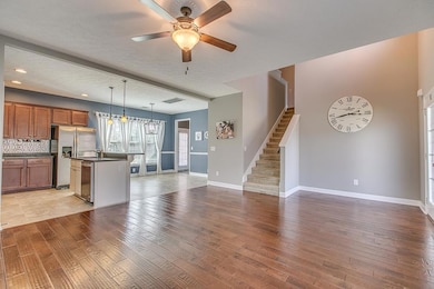  View from living room into kitchen and casual dining with stairs tucked away out of sight