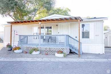 Manufactured / mobile home featuring a metal roof and a deck