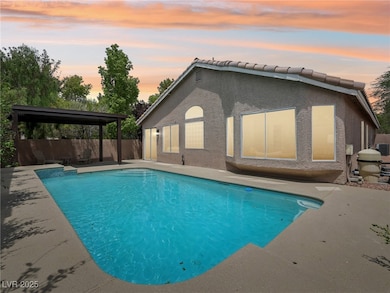 View of pool with a patio area and a fenced backya