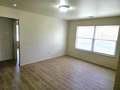 Empty room featuring wood finished floors, a textu