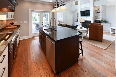 Kitchen with sink, an island with sink, light hard