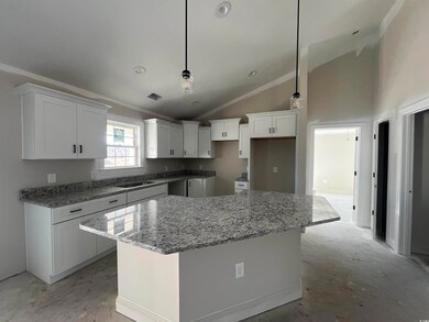 Kitchen featuring high vaulted ceiling, a kitchen 