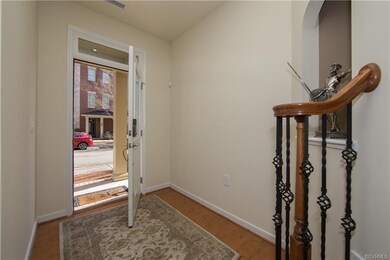 Foyer with wood laminate flooring system.