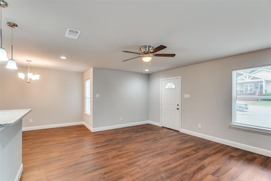 Foyer with wood finished floors, ceiling fan with 