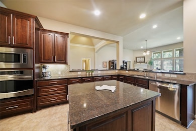 Huge kitchen features a large island with loads of cabinets & counterspace.