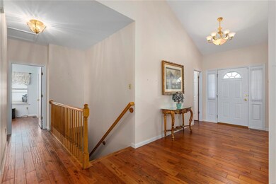 Foyer leads to open 20 x 19 vaulted family room an