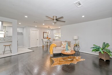 Large Family room as part of open floorplan with views of kitchen and dining areas.