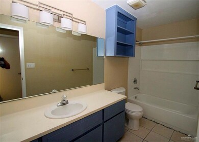 Full bath with toilet, tile patterned floors, vanity, and tub / shower combination