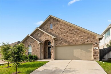 View of front of home featuring brick siding, dri