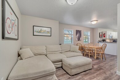Living area featuring wood finished floors and a textured ceiling