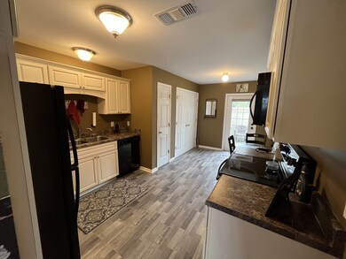 Kitchen with pantry & laundry.