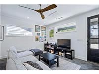 Living room with ceiling fan and baseboards