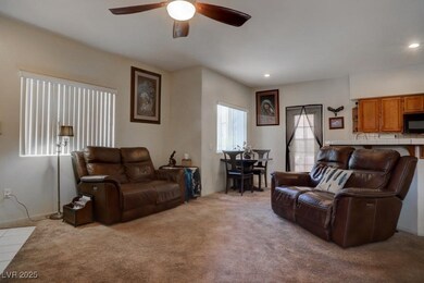 Living room featuring light carpet and ceiling fan