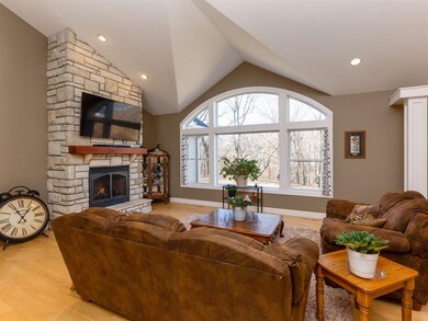 Stone gas fireplace, maple flooring and woodland v