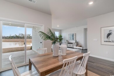Dining space with dark wood-style flooring, baseboards, and recessed lighting