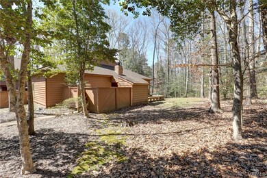 Side view of home.  Enclosed area for heat pump an