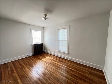 Unfurnished room with radiator and dark hardwood / wood-style flooring