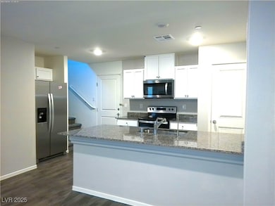 Kitchen featuring stainless steel appliances, a si