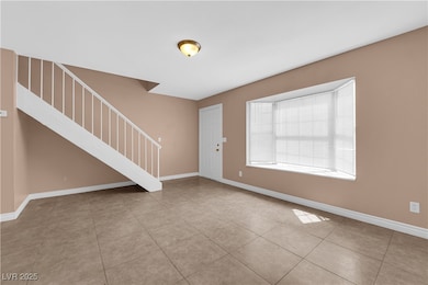 Entryway with stairs and tile patterned flooring