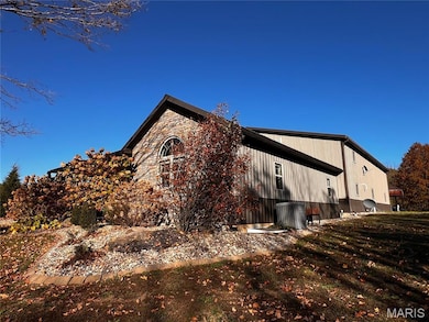 View of side of property featuring stone siding
