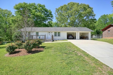 Ranch-style house featuring driveway, fence, an at