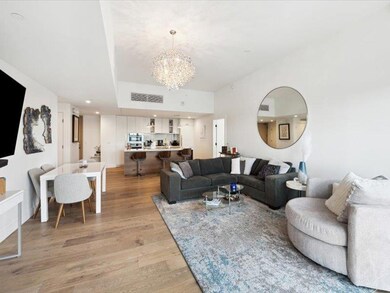 Living area with a chandelier, light wood-style f