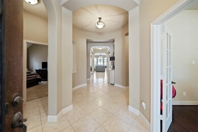 Elegant entry hall with soaring ceilings, tile flo