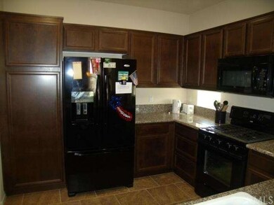 Refrigerator and cabinets of dark wood 