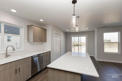 Kitchen featuring dishwasher, dark wood finished floors, pendant lighting, recessed lighting, and modern cabinets
