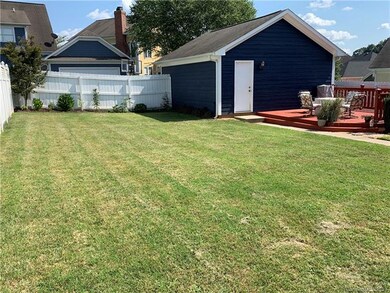 Yard view of garage and deck