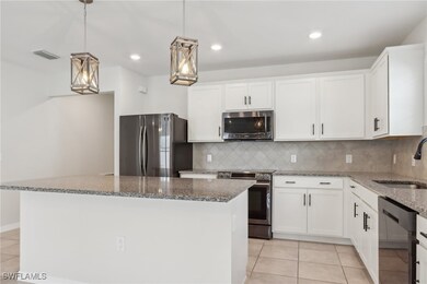 Kitchen with light tile patterned flooring, a sink