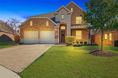 View of property with a garage and a front lawn