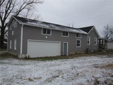 Back of property featuring a garage