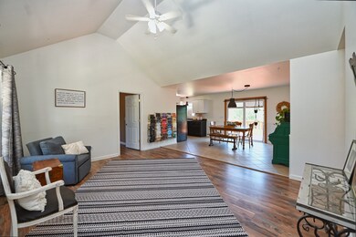 Vaulted ceiling in the living area that opens to the dining and kitchen.