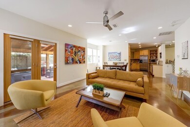 Living area with a ceiling fan, recessed lighting