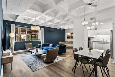 Dining area with billiards table, light wood-style floors, coffered ceiling, and beamed ceiling