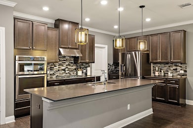 Kitchen featuring a sink, dark countertops, visib