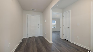Corridor with dark hardwood / wood-style flooring